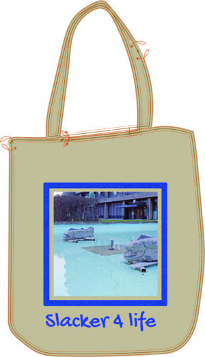 Beige tote bag with a framed photo of two stone fish sculptures in a blue fountain pool, titled βSlacker 4 Lifeβ